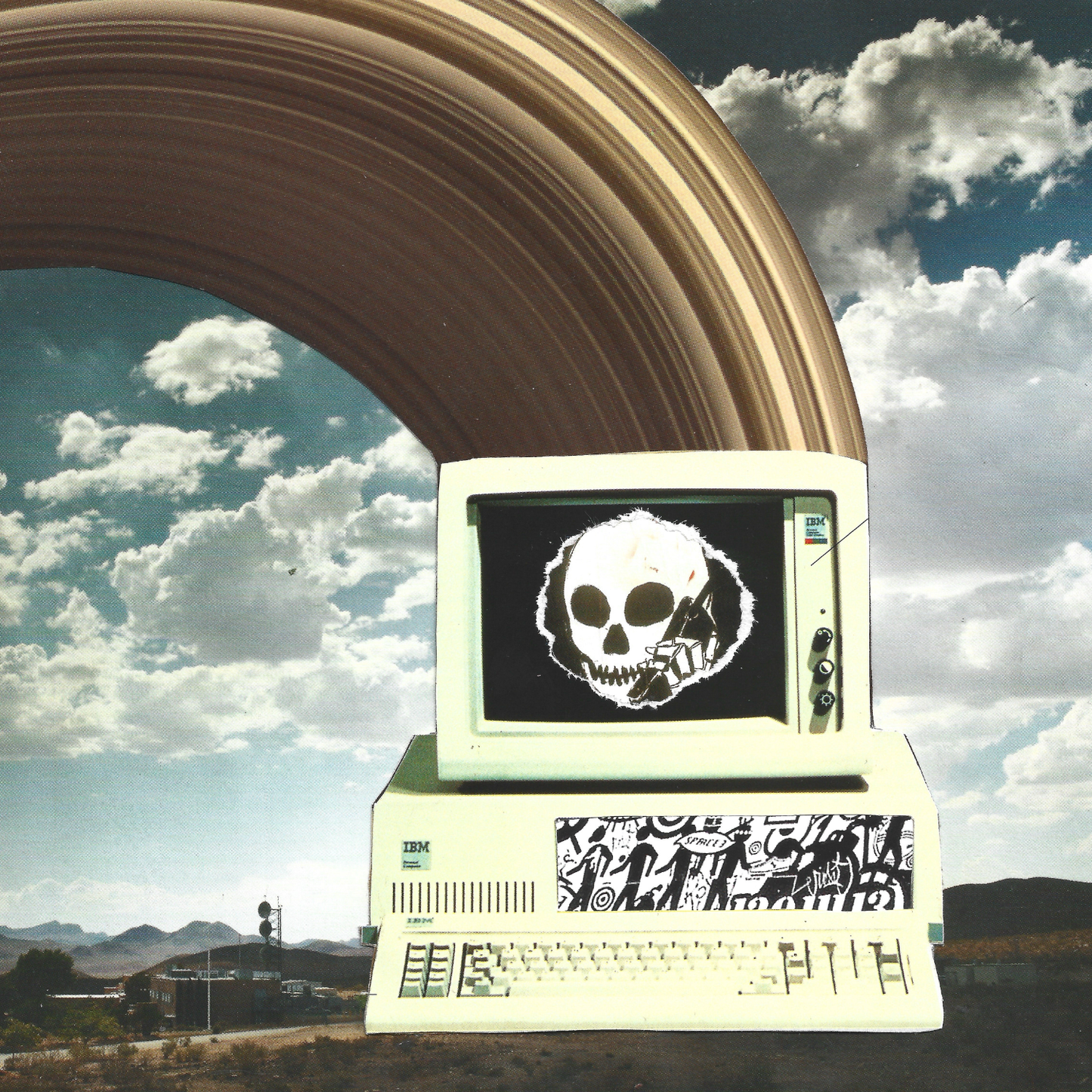 A collage of retro beige computer monitor and keyboard against a dramatic sky, with a large curved arch rising behind it. The screen shows a black background with a white skull graphic, and the front has graffiti-style artwork.